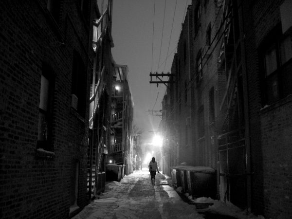 A woman walks alone in a dark alley. Photo by renee_mcgurk via Flickr.