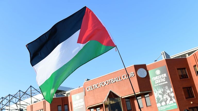 A single Palestinian flag flies in front of the Celtic FC stadium.